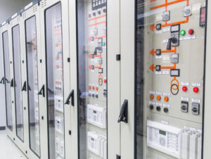 Industrial PLC control panel and electrical cabinet inside manufacturing facility