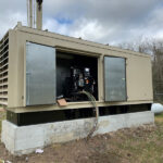 Standby diesel generator installed outside a commercial facility for emergency backup power