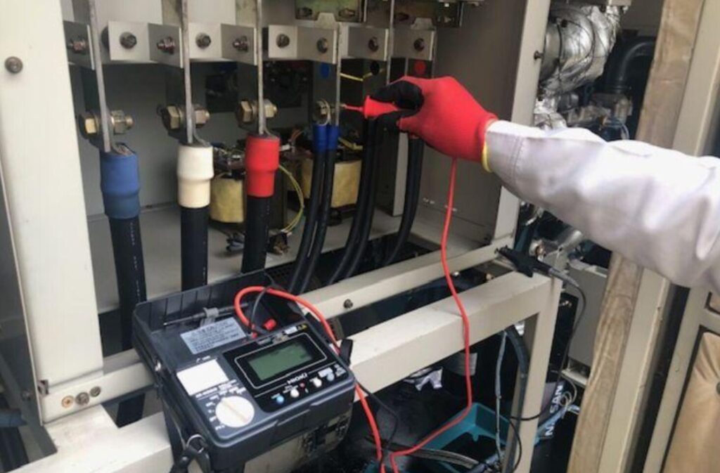 Checking three phase diesel generator voltage during load testing