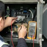 Technician testing a generator AVR with a multimeter